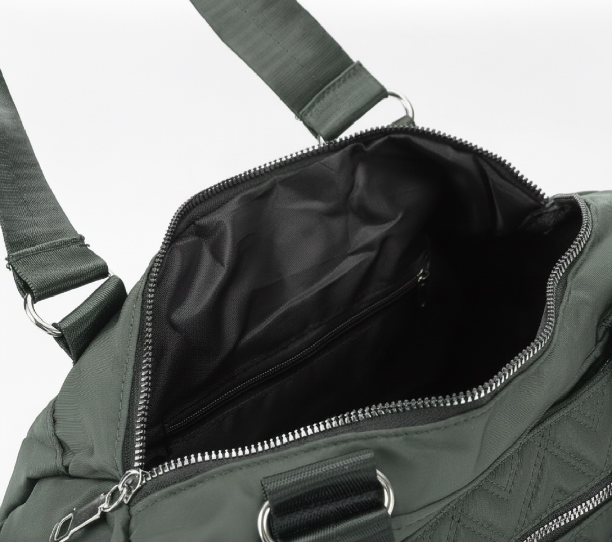 Green CROSSLAND quilted duffel bag with black handles, detachable shoulder strap, and multiple silver zippered pockets, shown against a white background.