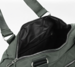 Green CROSSLAND quilted duffel bag with black handles, detachable shoulder strap, and multiple silver zippered pockets, shown against a white background.