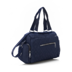 Navy blue CROSSLAND quilted duffel bag with black handles, detachable shoulder strap, and multiple silver zippered pockets, shown against a white background.